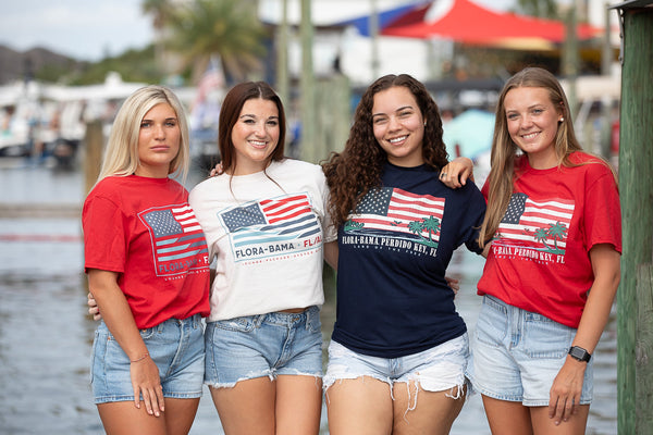 girls on a dock in tshirts with american flag 