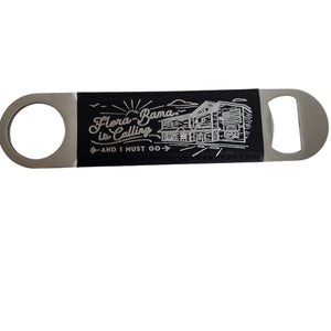 metal bottle opener with black background and white sketch of flora bama building