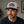 Man wearing a cap with 'America the Beautiful' text in an indoor setting and flora bama logo on the side