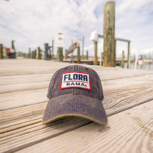 Navy blue cap with 'Flora Bama' text on a white patch
