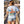 Person wearing a light blue t-shirt with a ship and American flag design, standing on a wooden dock.