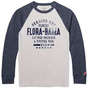 A long sleeve baseball t-shirt with dark blue sleeves and a cream color torso. The shirt has text 'FLORA-BAMA' printed on it.