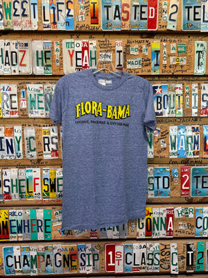 A blue Flora-Bama brand t-shirt with a wavy yellow logo on the front hanging on license plates
