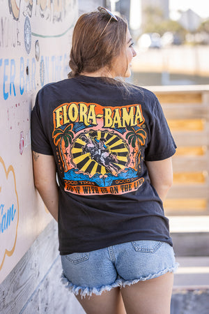 Person wearing shirt with palm trees, geo pattern and person riding a bull with flora bama logo