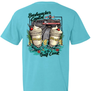 light blue t-shirt with a graphic design of two bushwackers and the flora bama buidling  on the back 