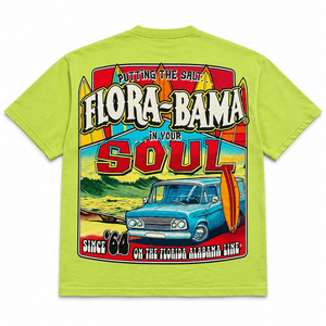 Lime green t-shirt with a colorful graphic design featuring a vintage car and surfboard, text 'Flora-Bama', and a graphic of a beach scene.