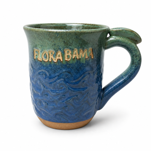 Ceramic mug with 'Flora Bama' text on a white background