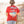 Person wearing a red 'Flora-Bama' t-shirt with beach graphics on a beach.