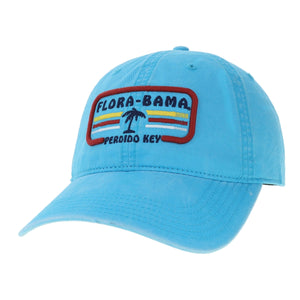 A blue Flora-Bama cap with a curved visor and a patch on the front featuring the Flora-Bama text in dark blue with a palm tree and colored lines