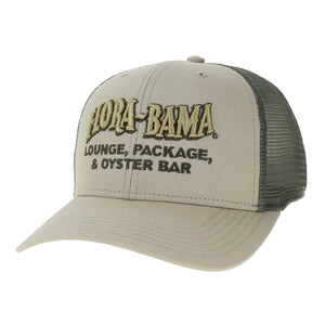 A tan Flora-Bama branded trucker cap with a mid-profile structured crown, a slightly curved visor, and an open back snap closure with green mesh. 