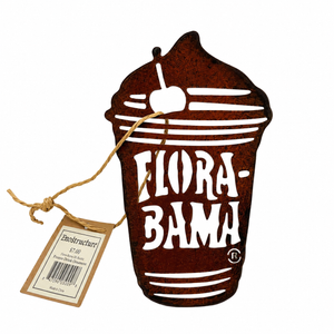 Decorative metal sign shaped like a cup with 'Flora-Bama' text, featuring a cherry on top, on a white background.