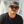 Man wearing sunglasses and a cap with a blurred background
