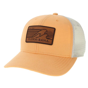 orange hat with  brown patch on the front with brown waves and flora bama text with white mesh backing
