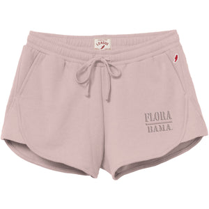 A pair of light pink sweat shorts with a drawstring waist, featuring 'FLOHA DANA.' printed on the left leg and a small red logo on the right hip, set against a plain white background.