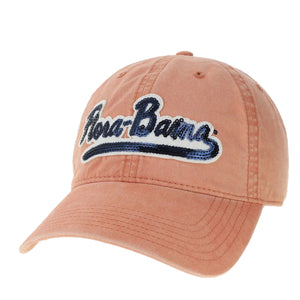 A orange baseball cap with 'Flora-Bama' written in blue sequins on the front.