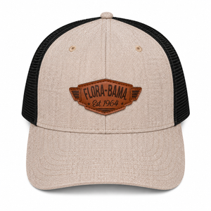 Beige and black cap with leather Flora-Bama logo on a wing patch 