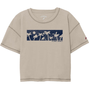 A beige colored crop crew t-shirt with a waffle fabric texture and a graphic print of palm trees 