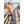 Woman in peach shirt and denim shorts with cowboy boots standing on a wooden boardwalk by the beach.