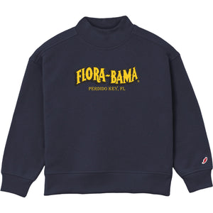 A navy blue crewneck sweatshirt featuring 'FLORA-BAMA' and 'PERDIDO KEY, FL' printed in yellow on the chest, with a small Champion logo on the left sleeve cuff.