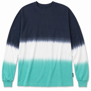 Long-sleeve shirt with a gradient color pattern from navy to white to teal on a white background.