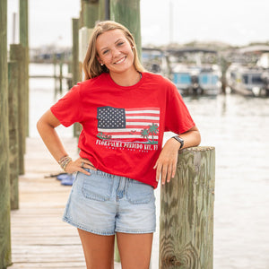 red t-shirt with American flag and palm tree design and flora bama text below