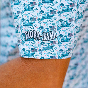 Close-up of a person wearing a patterned shirt with 'Flora-Bama' branding.