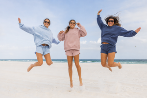 girls jumping in reverse fleece shorts and sweatshirts