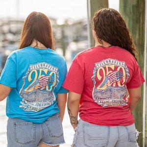 Two people wearing blue and red t-shirts with a 250th anniversary design.