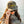 Person wearing a camouflage cap with 'Flora-Bama' yellow logo