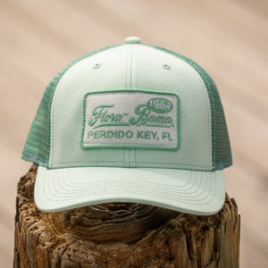 Light blue cap with a green mesh back and logo on a white background