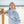 Person wearing a light blue sweatshirt with text on a beach