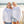 Two people wearing white sweatshirts with flora bama text, standing on a beach.