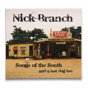 Album cover of 'Songs of the South and a lost dog too' by Nick Branch featuring a rustic building and sign.