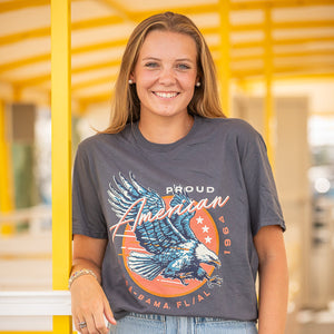 woman wearing Gray t-shirt with an eagle graphic and flora bama text 
