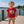 kid on a dock wearing a red t-shirt with 'My First Flora-Bama' printed in blue and yellow lettering, featuring an anchor graphic and text.